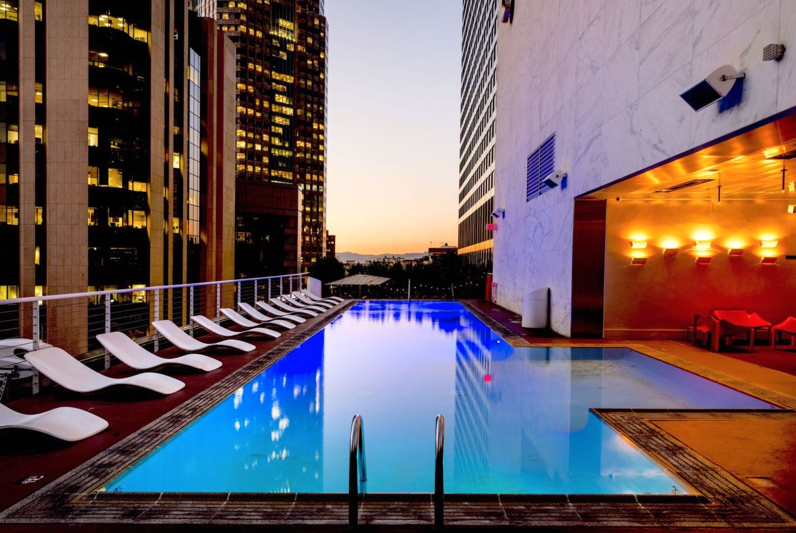 Indoor-outdoor pool illuminated at dusk