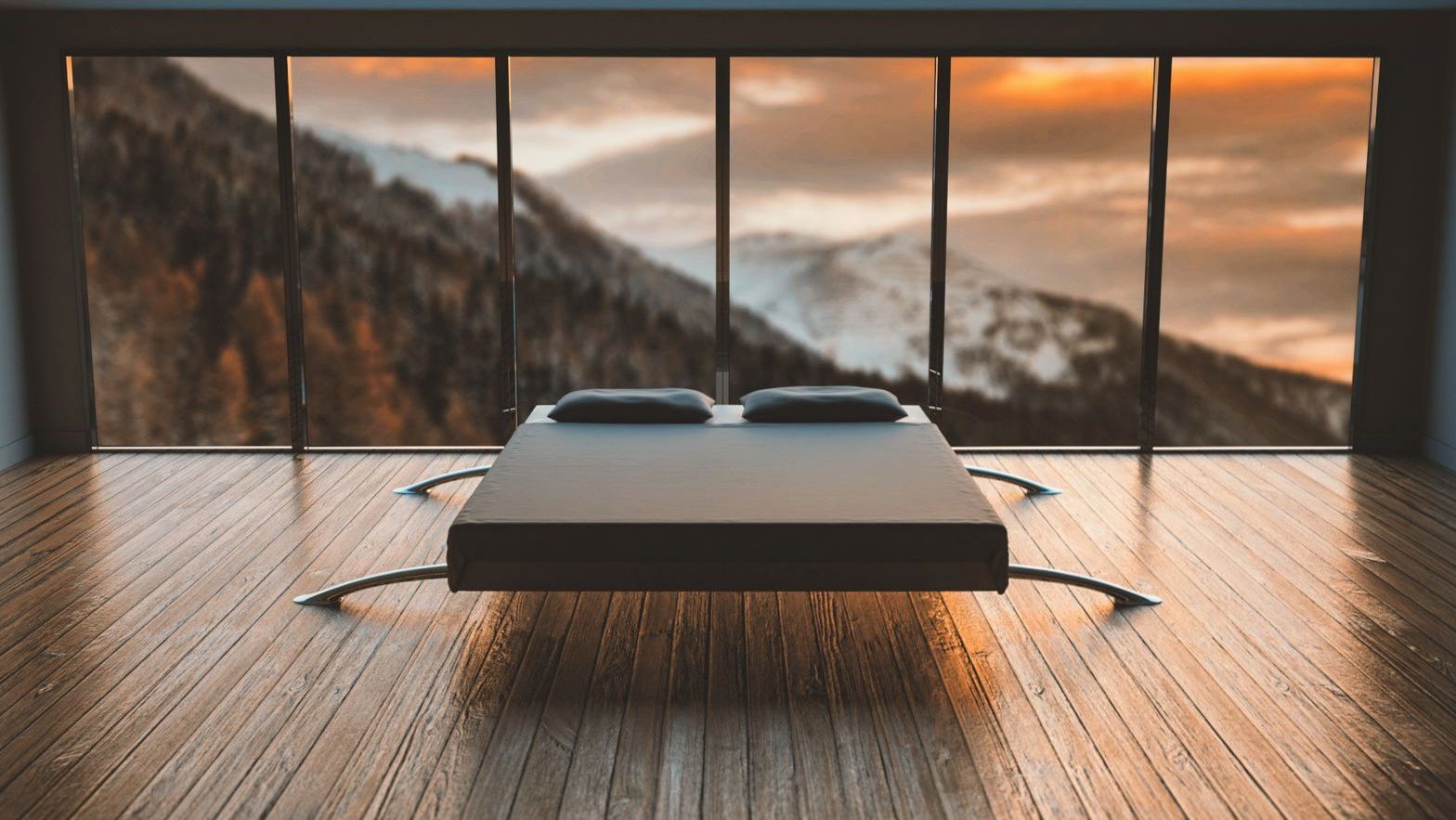 Suite bed facing floor-to-ceiling windows with a snow-capped mountain view